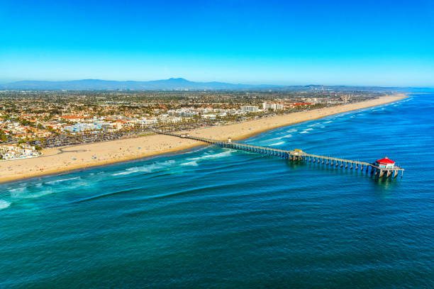 Aerial view of the beautiful Orange County California coastal town of Huntington Beach from an altitude of about 1000 feet over the Pacific Ocean during a helicopter photo flight.